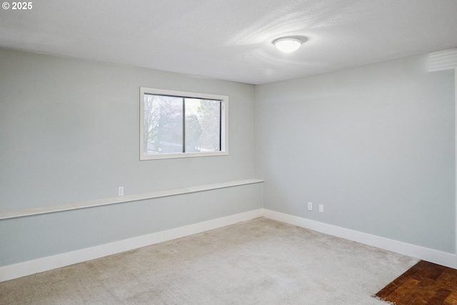 carpeted empty room with a textured ceiling