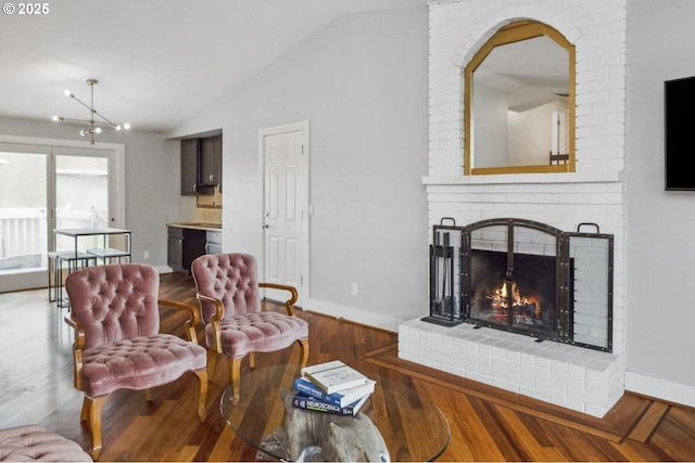 living room featuring lofted ceiling, a fireplace, and dark wood-type flooring