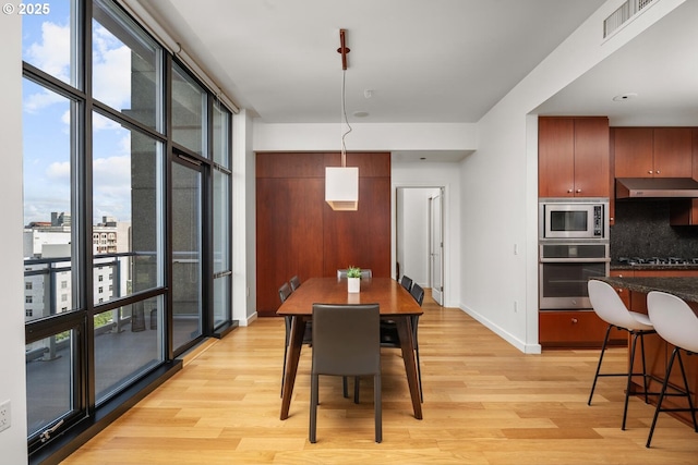 1025 NW Couch St Unit 1320, Portland, OR 97209 - dining area with light wood-style flooring and healthy amount of natural light