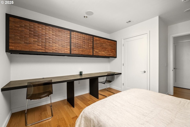 1025 NW Couch St Unit 1320, Portland, OR 97209 - bedroom featuring light wood finished floors and an office area