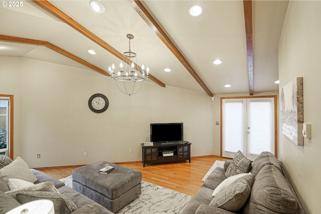 living room featuring a notable chandelier, light hardwood / wood-style flooring, french doors, and vaulted ceiling with beams