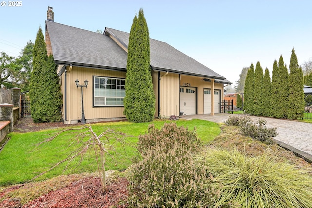 view of front of property with a garage and a front yard