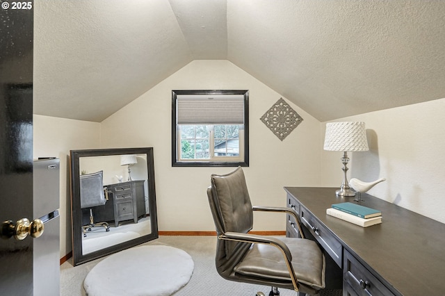 carpeted home office with lofted ceiling and a textured ceiling