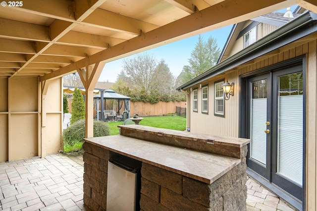 view of patio featuring a gazebo, french doors, and an outdoor bar