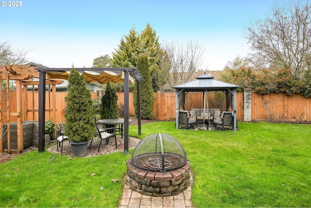 view of yard featuring a gazebo and an outdoor living space with a fire pit