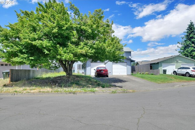 814/816 W Quinalt St, Springfield, OR 97477 - view of property hidden behind natural elements with asphalt driveway and an attached garage