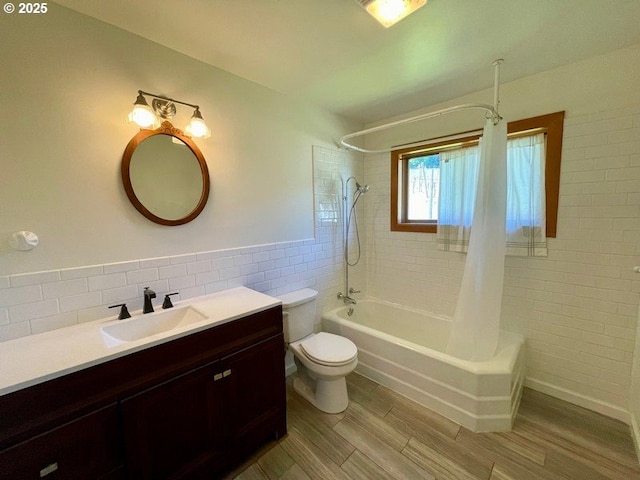 11081 Cook Underwood Rd, Underwood, WA 98651 - full bathroom featuring tile walls, shower / bath combo with shower curtain, vanity, toilet, and wood finished floors