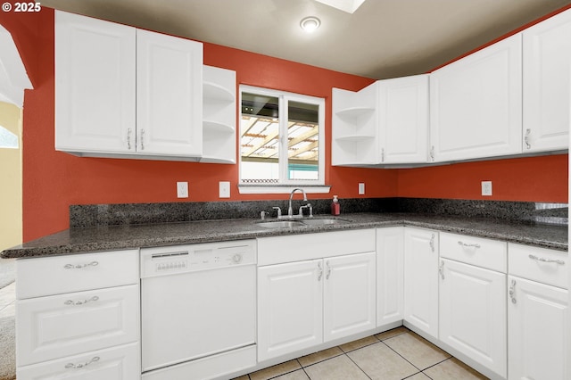 kitchen with white cabinets, dishwasher, light tile patterned floors, and sink