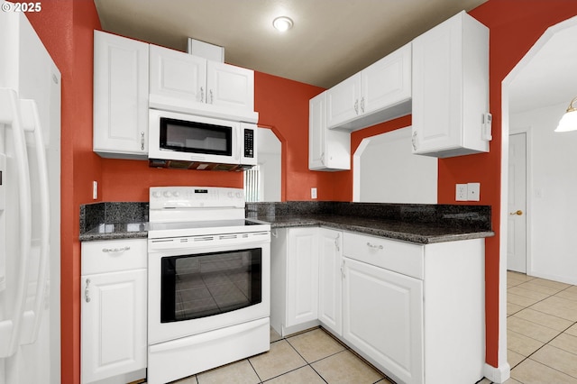 kitchen with white appliances, light tile patterned floors, and white cabinets