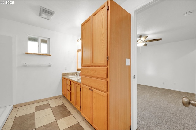 bathroom featuring vanity, tile patterned flooring, and ceiling fan