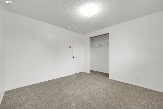 unfurnished bedroom with a closet, a textured ceiling, and carpet floors