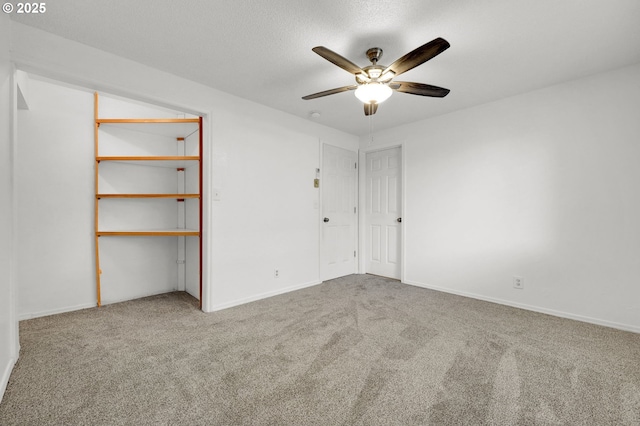 unfurnished room with ceiling fan and carpet flooring