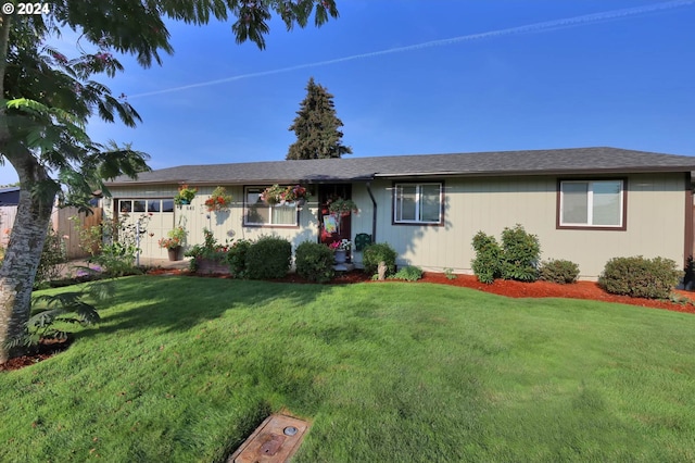 ranch-style home with a front lawn