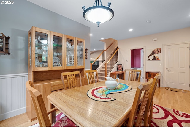 10886 SW Bretton Ct, Portland, OR 97224 - dining area featuring stairs, light wood-style flooring, and wainscoting