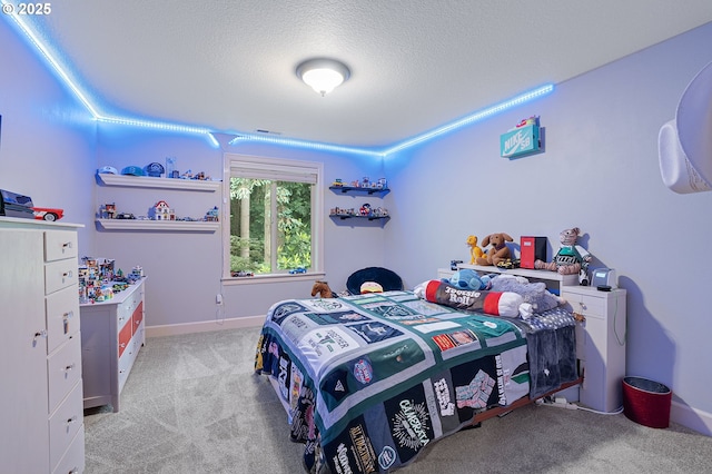 10886 SW Bretton Ct, Portland, OR 97224 - bedroom with light colored carpet, a textured ceiling, and baseboards