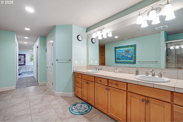 10886 SW Bretton Ct, Portland, OR 97224 - ensuite bathroom featuring double vanity, a shower stall, recessed lighting, tile patterned floors, and baseboards