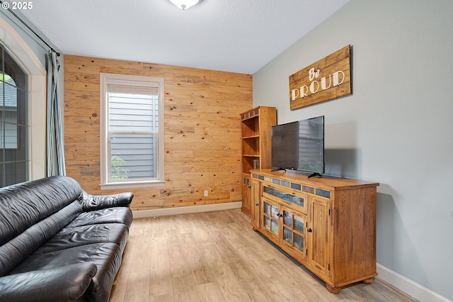 10886 SW Bretton Ct, Portland, OR 97224 - living room featuring wood walls, baseboards, light wood finished floors, and a textured ceiling