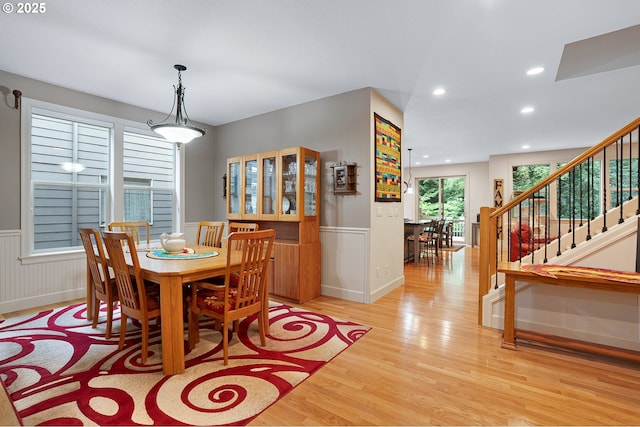 10886 SW Bretton Ct, Portland, OR 97224 - dining space featuring wainscoting, light wood-style flooring, stairs, and recessed lighting