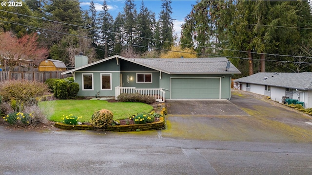 ranch-style house featuring a front lawn, fence, a chimney, driveway, and an attached garage