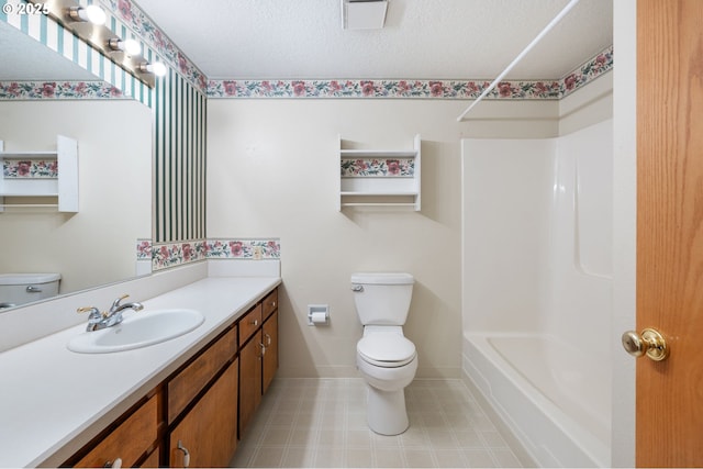 full bathroom with baseboards, toilet, vanity, and a textured ceiling