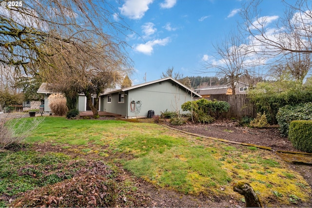 exterior space featuring fence and a lawn