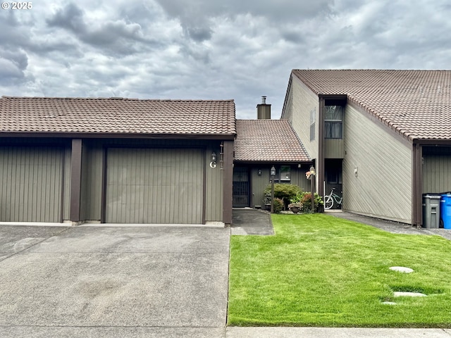 13821 NW 10th Ct Unit G, Vancouver, WA 98685 - multi unit property featuring a tile roof, a front yard, driveway, a garage, and a chimney