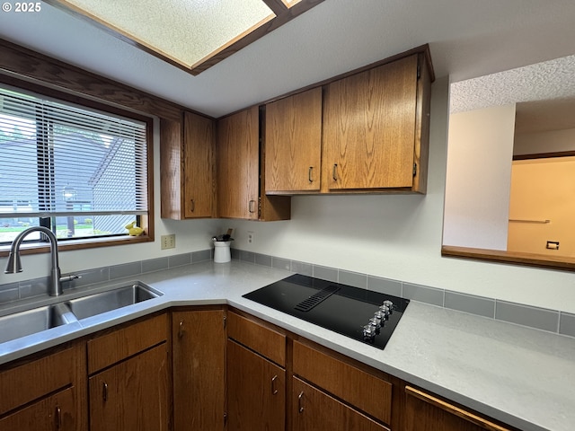 13821 NW 10th Ct Unit G, Vancouver, WA 98685 - kitchen featuring black electric stovetop, a sink, and light countertops