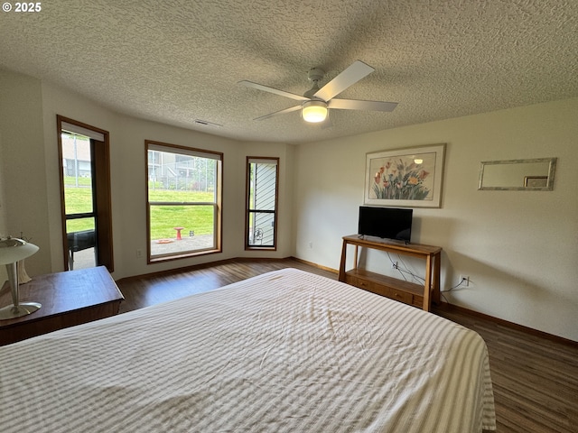 13821 NW 10th Ct Unit G, Vancouver, WA 98685 - bedroom with multiple windows, a textured ceiling, dark wood-type flooring, and baseboards