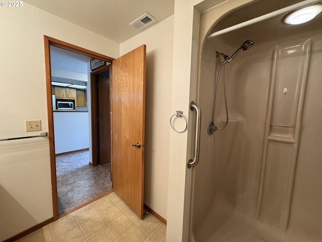13821 NW 10th Ct Unit G, Vancouver, WA 98685 - full bathroom featuring a walk in shower and baseboards