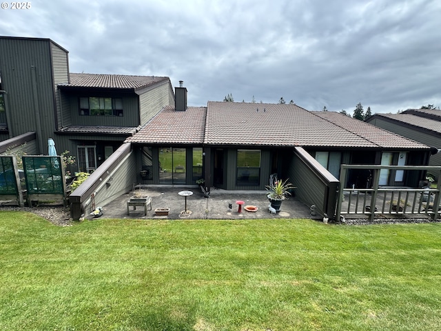 13821 NW 10th Ct Unit G, Vancouver, WA 98685 - back of property featuring a chimney, a patio area, a tiled roof, and a lawn