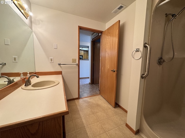 13821 NW 10th Ct Unit G, Vancouver, WA 98685 - bathroom featuring a shower stall, baseboards, and vanity