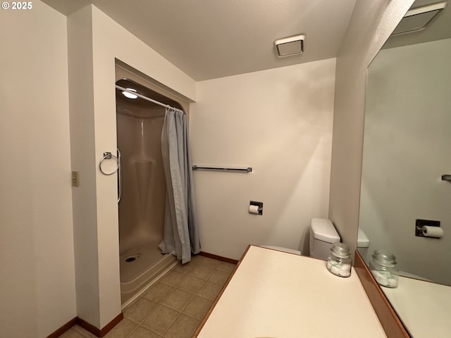 13821 NW 10th Ct Unit G, Vancouver, WA 98685 - full bath with a shower with shower curtain, baseboards, toilet, vanity, and tile patterned floors