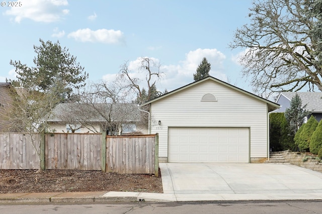 exterior space featuring concrete driveway and fence