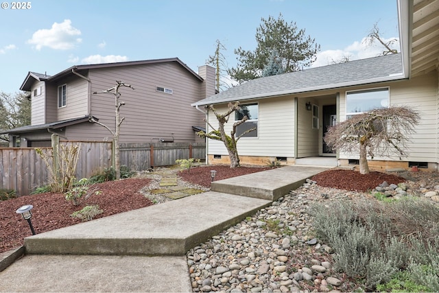 view of home's exterior featuring crawl space, a shingled roof, a chimney, and fence