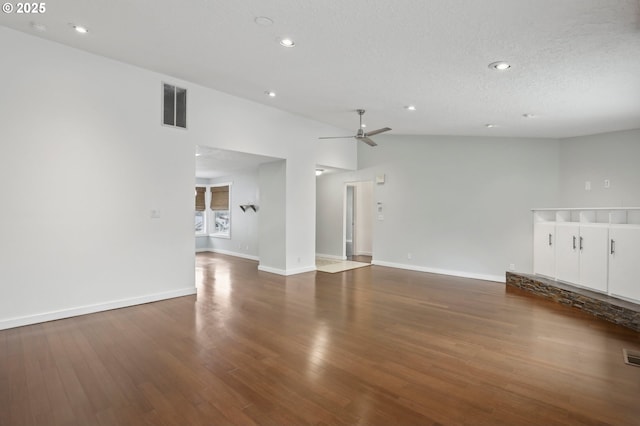 unfurnished living room featuring wood finished floors, visible vents, baseboards, recessed lighting, and a textured ceiling