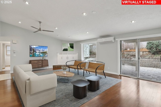 living area featuring recessed lighting, an AC wall unit, and wood finished floors