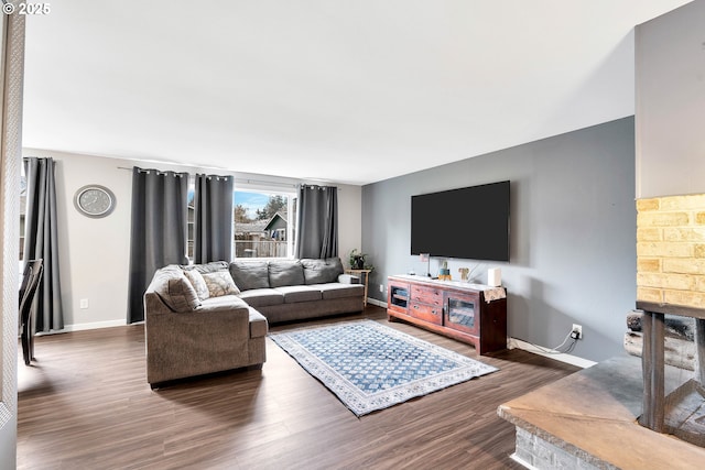 living room with baseboards and dark wood-style flooring