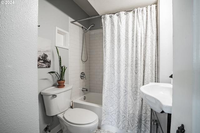 full bathroom with sink, shower / bath combo with shower curtain, and toilet