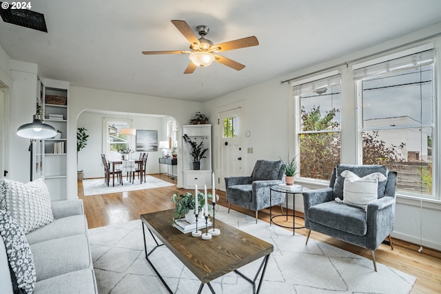 living room featuring light hardwood / wood-style flooring, plenty of natural light, and ceiling fan