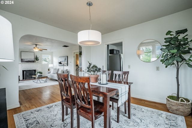 dining area with hardwood / wood-style flooring, ceiling fan, and a healthy amount of sunlight