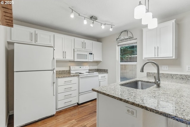 7091 SE Austin Dr, Hillsboro, OR 97123 - kitchen featuring white appliances, white cabinets, light wood-style flooring, and light stone countertops
