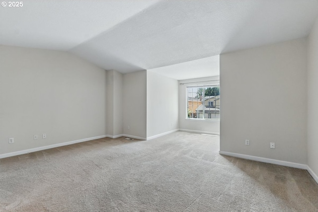 7091 SE Austin Dr, Hillsboro, OR 97123 - unfurnished living room with carpet flooring and vaulted ceiling