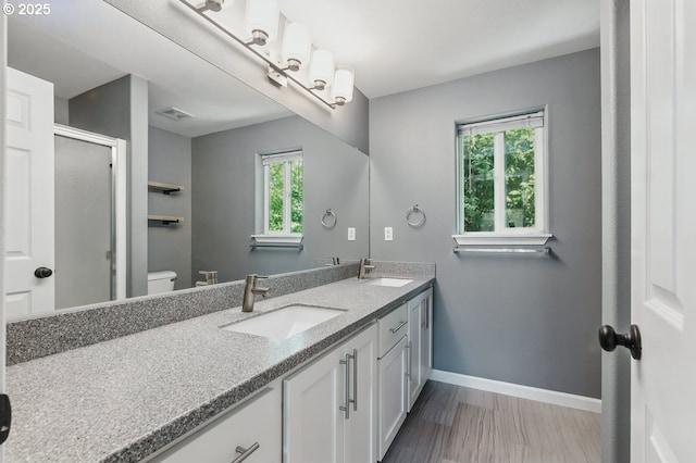 7091 SE Austin Dr, Hillsboro, OR 97123 - full bath with double vanity, a shower with door, and wood finished floors