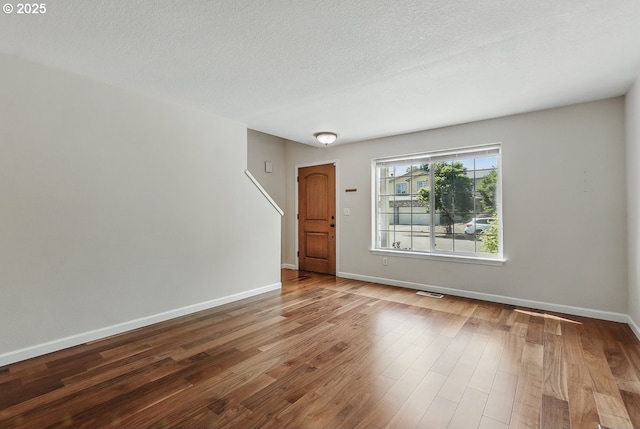 7091 SE Austin Dr, Hillsboro, OR 97123 - spare room with wood finished floors and a textured ceiling
