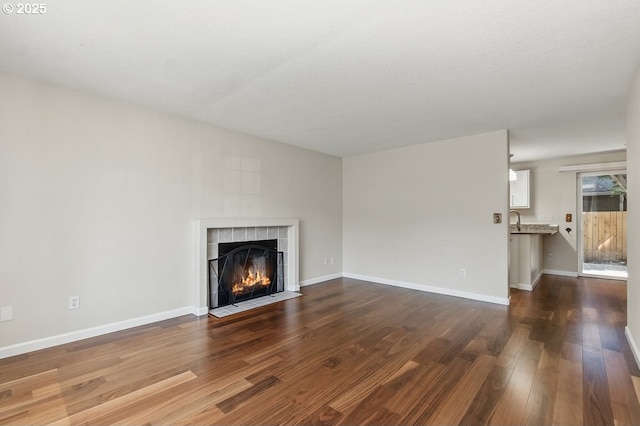 7091 SE Austin Dr, Hillsboro, OR 97123 - unfurnished living room with dark wood finished floors and a tile fireplace