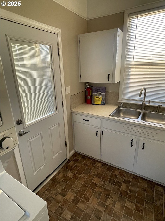 kitchen featuring white cabinetry and sink