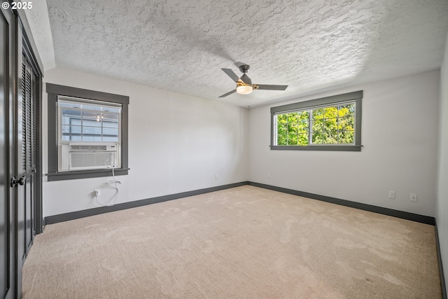 6406 N Michigan Ave, Portland, OR 97217 - carpeted spare room featuring a ceiling fan, baseboards, cooling unit, and a textured ceiling