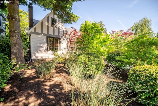 6406 N Michigan Ave, Portland, OR 97217 - view of home's exterior featuring a chimney and roof with shingles