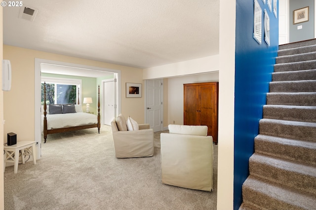 2977 Ingalls Way, Eugene, OR 97405 - living area with carpet floors, stairs, and a textured ceiling
