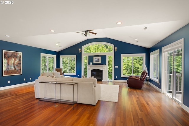 2977 Ingalls Way, Eugene, OR 97405 - living area featuring wood finished floors, ceiling fan, a glass covered fireplace, lofted ceiling, and baseboards
